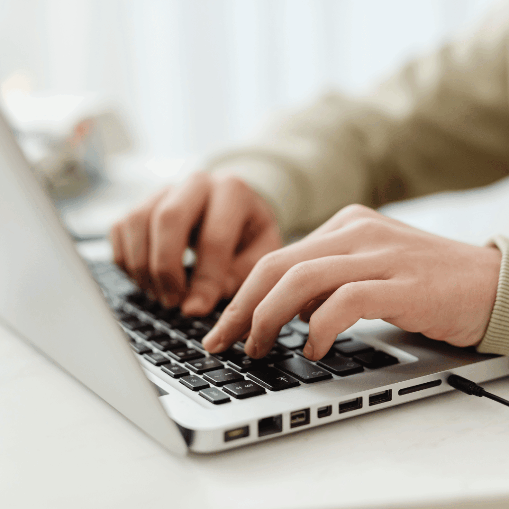 dietitian typing their resume on a computer