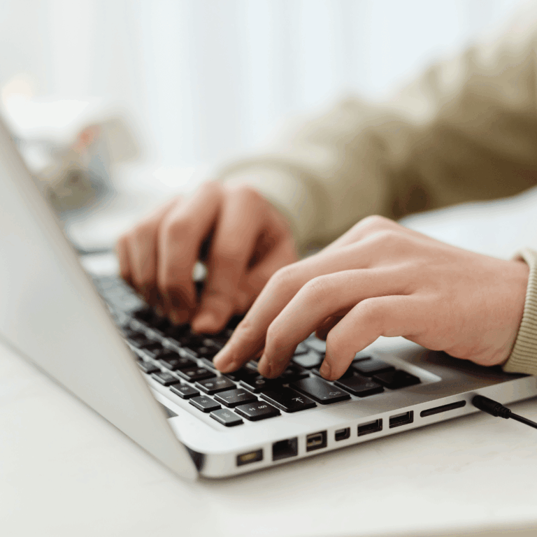 dietitian typing their resume on a computer